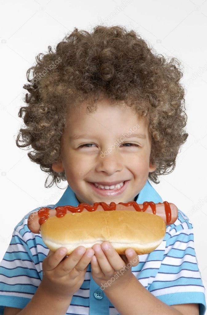Little kid eating hot dog,Kid holding hot dog.