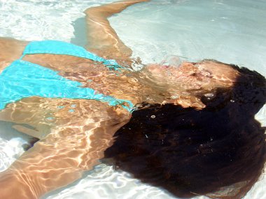 Young woman coming out from a water. clipart