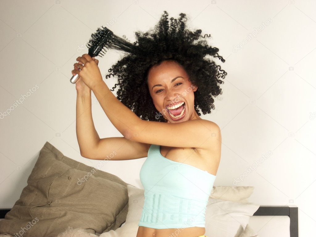 Afro american woman using a comb.