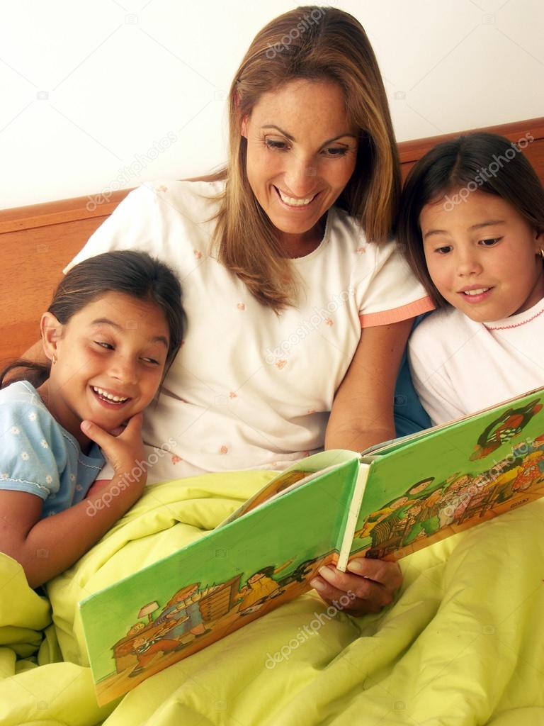 Mother and daughters reading a book together