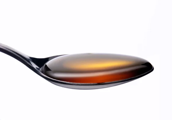 Honey on a teaspoon — Stock Photo, Image