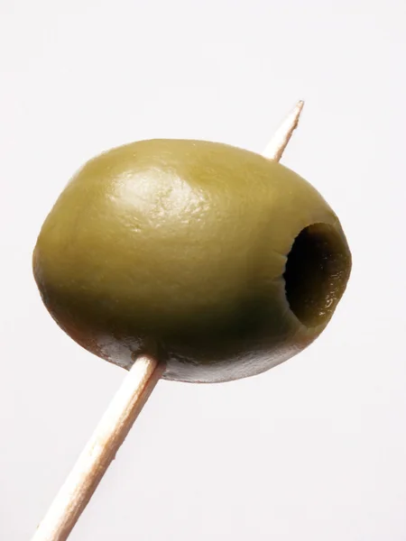 Olive on a toothpick — Stock Photo, Image