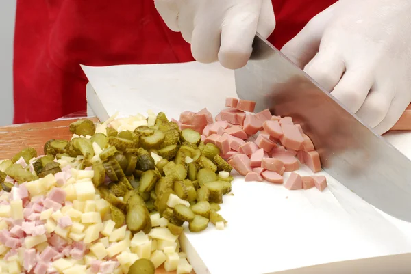 Cutting sausage,cucumber and cheese on white board — Stock Photo, Image