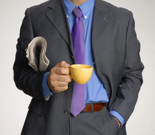 Businessman with a cup and newspaper — Stock Photo, Image