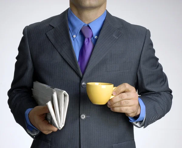 Empresario con una taza y periódico —  Fotos de Stock