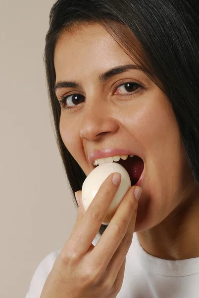 Young woman eating boiled egg. — Stock Photo, Image