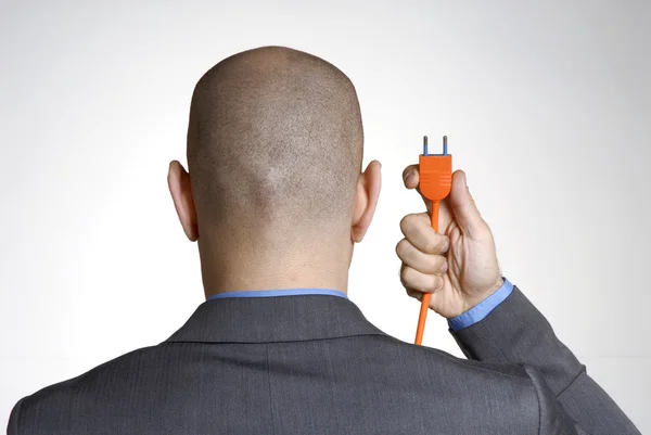 Visão traseira de um homem careca segurando um cabo elétrico. . — Fotografia de Stock