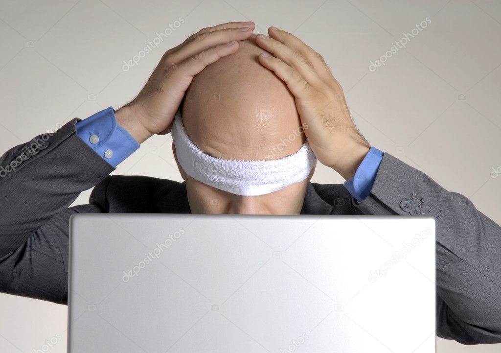 Confused blindfolded bald head man using a computer.