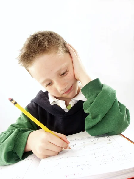 Liten skola unge på hans skrivbord — Stockfoto