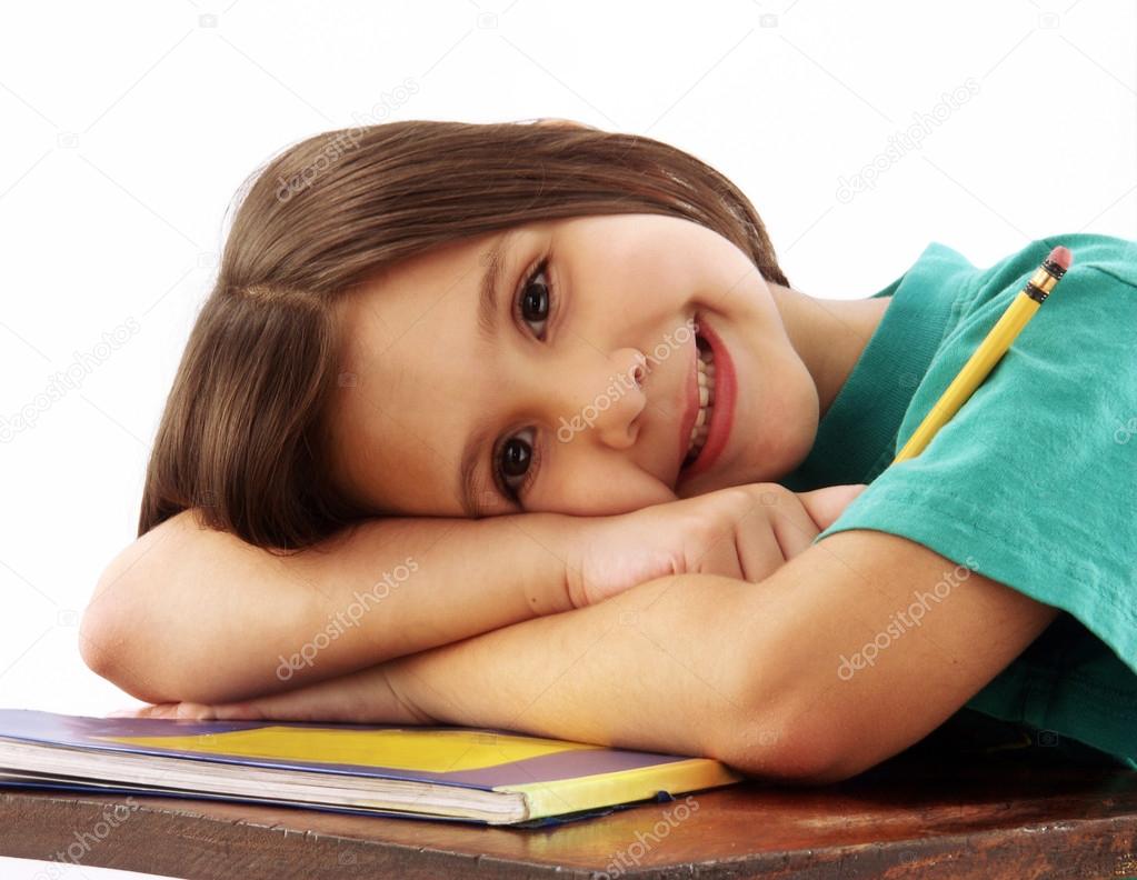 Little school girl on her desk