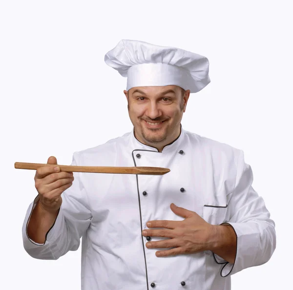 Cucinare con un cucchiaio di legno.Chef con un cucchiaio di legno . — Foto Stock