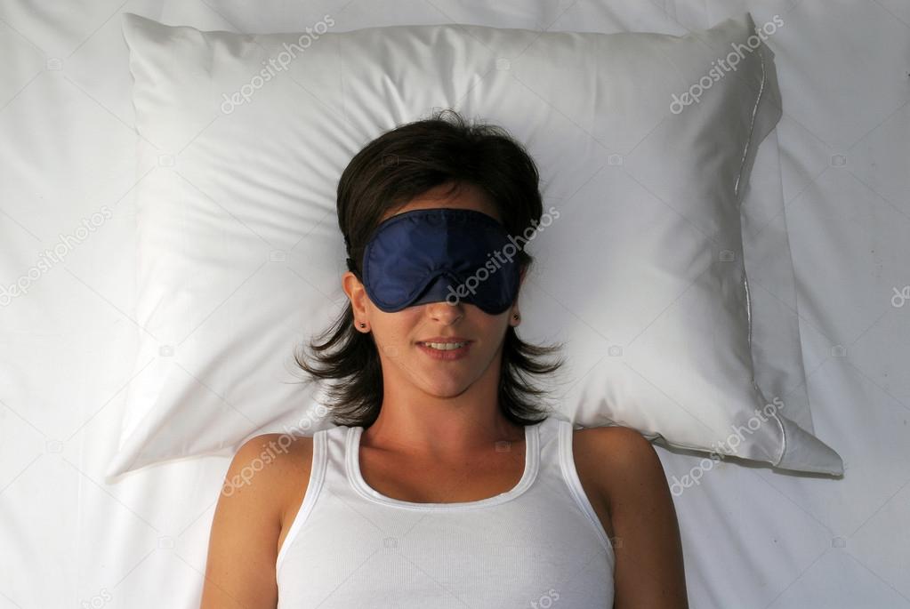 Beautiful sleeping young woman in sleep eye mask