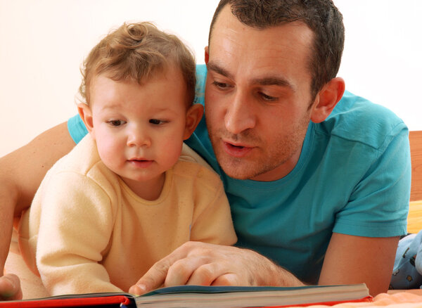 Happy father and his child reading book