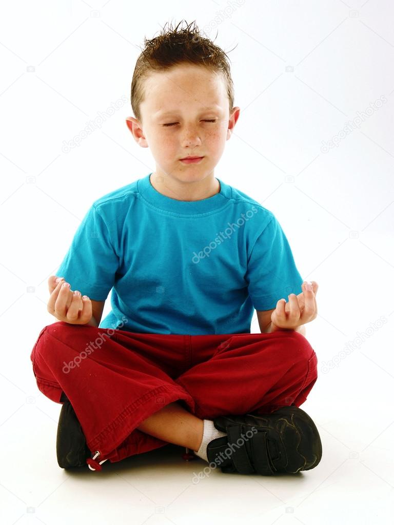 Little kid having relax doing yoga.
