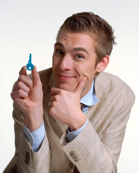 Salesman holding a key. — Stock Photo, Image