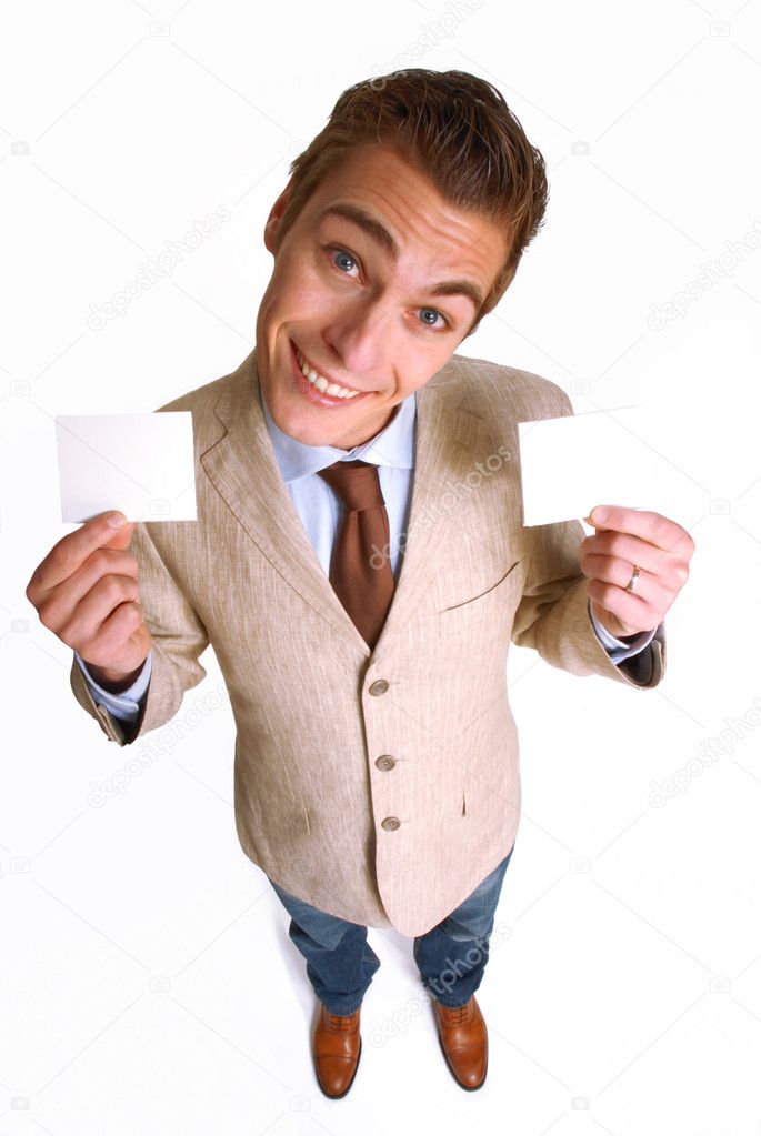 Young businessman holding two white cards.