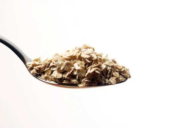 Cereal oats teaspoon on white background. — Stock Photo, Image