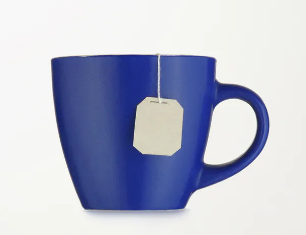 Blue cup with tea bag — Stock Photo, Image