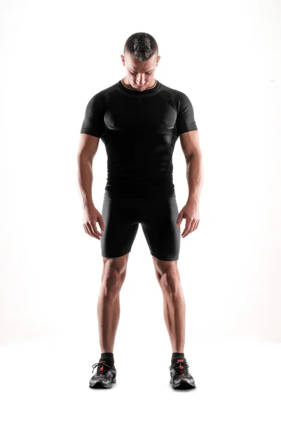 Athletic fitness man stående på vit bakgrund. — Stockfoto