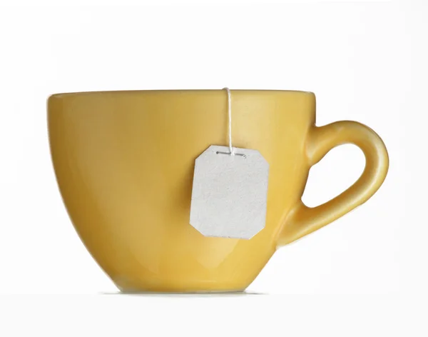 Hot tea bag on yellow cup. — Stock Photo, Image