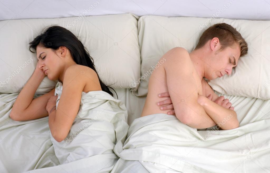 Annoying couple sleeping on bed.