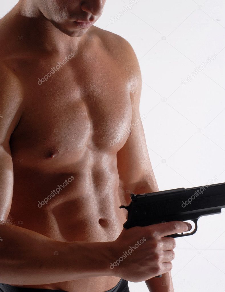 Muscular man holding gun