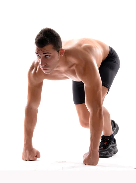 Gesunder und fitter Mann auf Laufstartposition auf weißem Hintergrund. — Stockfoto