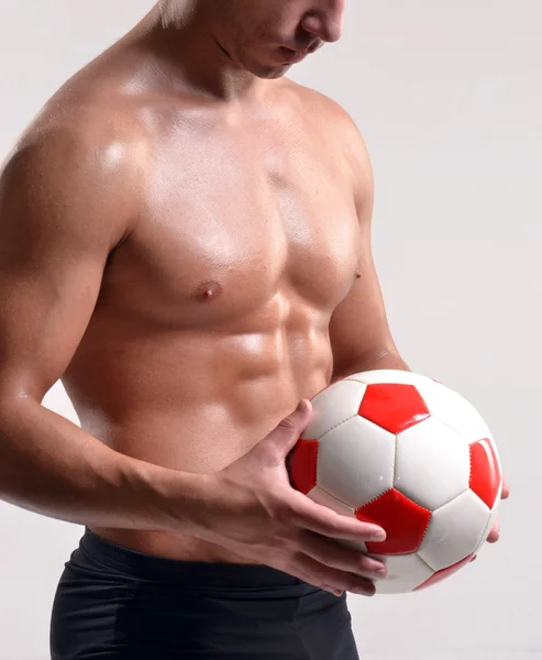 Fitness soccer player and a soccer ball. — Stock Photo, Image