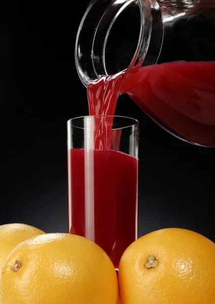 Pouring fresh red orange juice — Stock Photo, Image