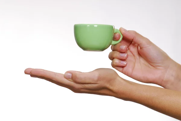 Un youg mano femenina sosteniendo una taza . — Foto de Stock