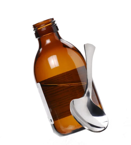 Una botella de jarabe y una cucharadita . —  Fotos de Stock