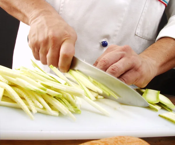 Mann schneidet Gemüse in Küche — Stockfoto