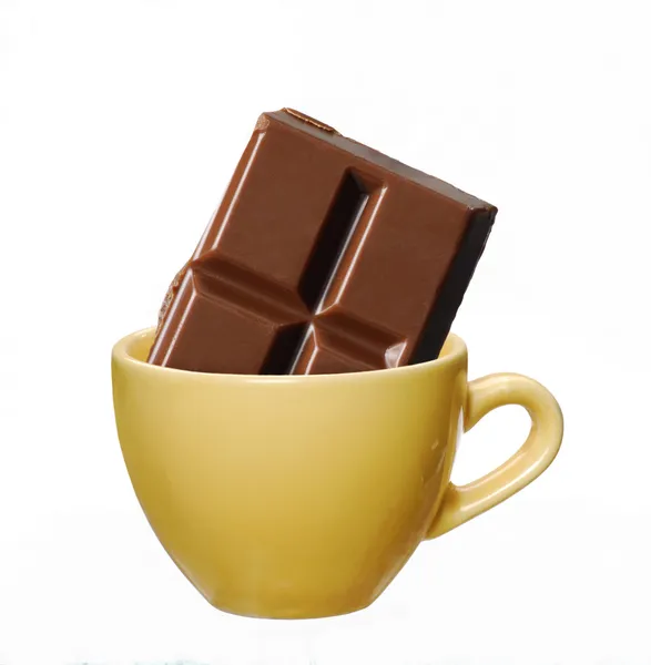 Yellow cup and choocolate bar on white background. — Stock Photo, Image