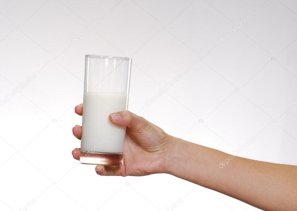 One youg female hand holding a glass of milk. — Stock Photo