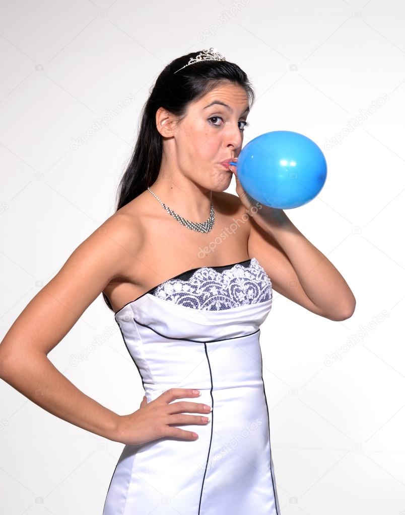 Funny bride blowing up a balloon
