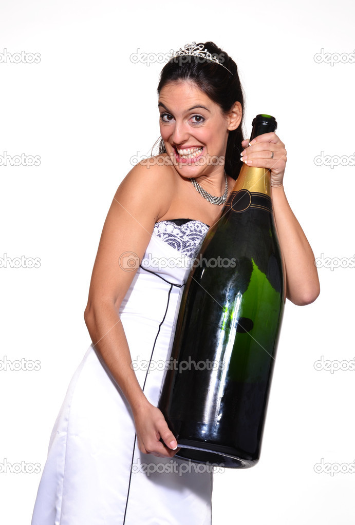 Happy bride holding a big champagne bottle Stock Photo by