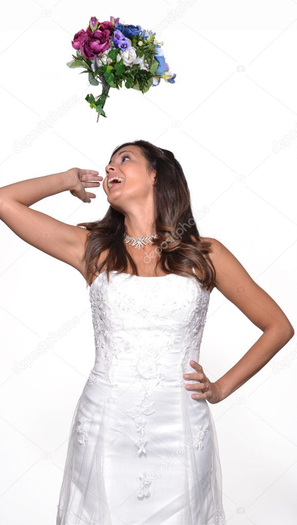 Happy bride throwing up a flowers bouquet