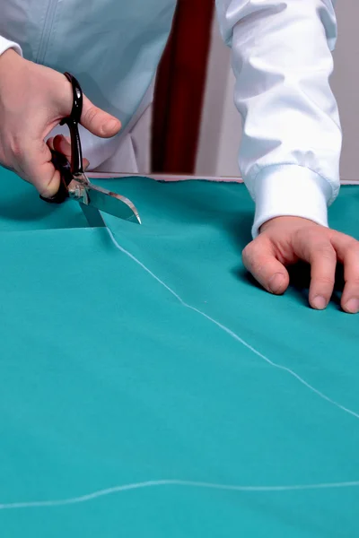 Cutting fabric with a taylor scissors — Stock Photo, Image