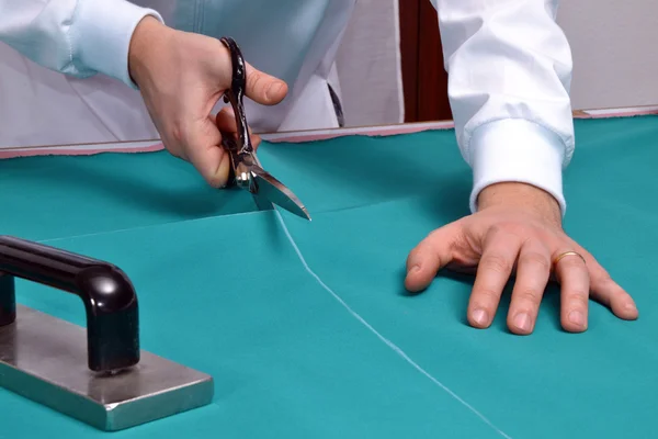 Cutting fabric with a taylor scissors — Stock Photo, Image