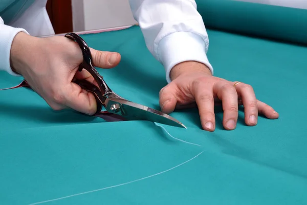 Cutting fabric with a taylor scissors — Stock Photo, Image