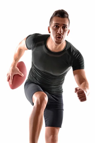 Homem segurando uma bola de rugby — Fotografia de Stock