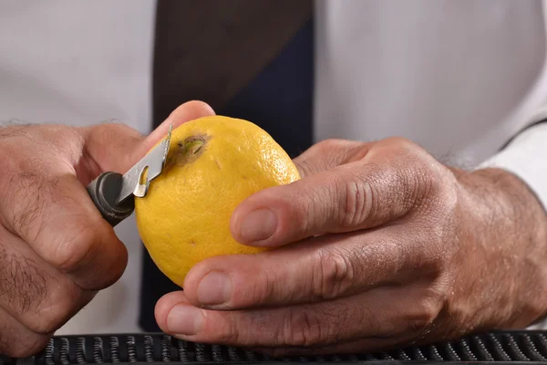 Barman peeling lemon — Stock Photo, Image