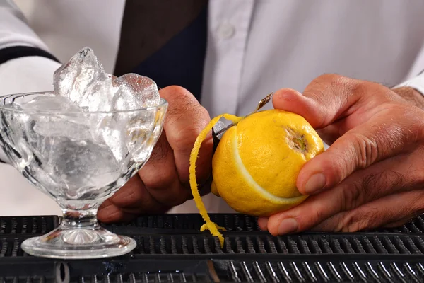 Barman peeling lemon — Stock Photo, Image