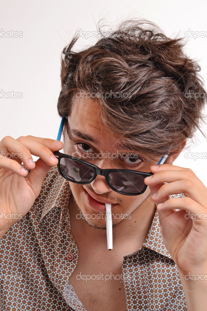 Smoking man wearing sunglasses.