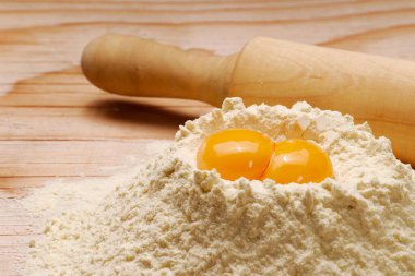 Mutfak masasında taze un ve yuvarlak arka planda sarı yumurta...