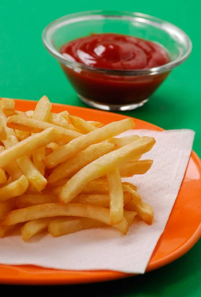 french fries potato chip dish and ketchup tomato sauce.