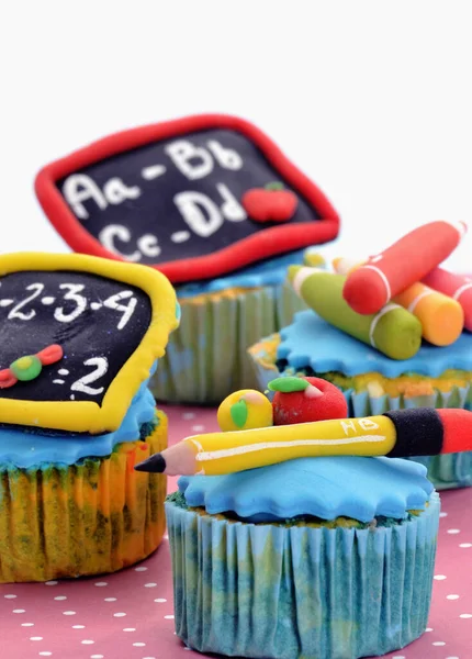 Back to school party cupcakes on school background.