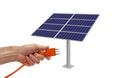 Alternatif enerji kavramı üzerine güneş paneli hücresine bir fiş bağlanıyor.