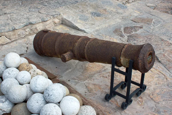 Old gun and stone cannonball