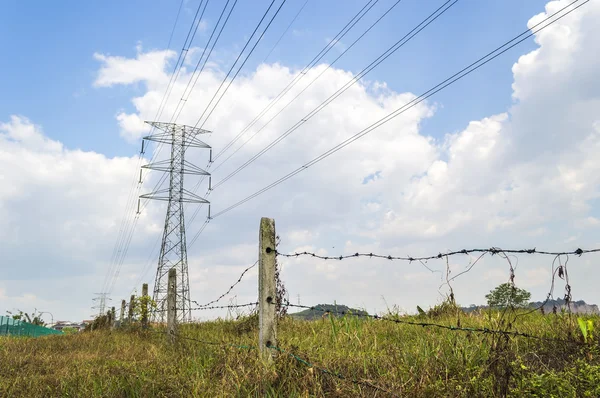 Fence and electrical tower — Stock Photo, Image